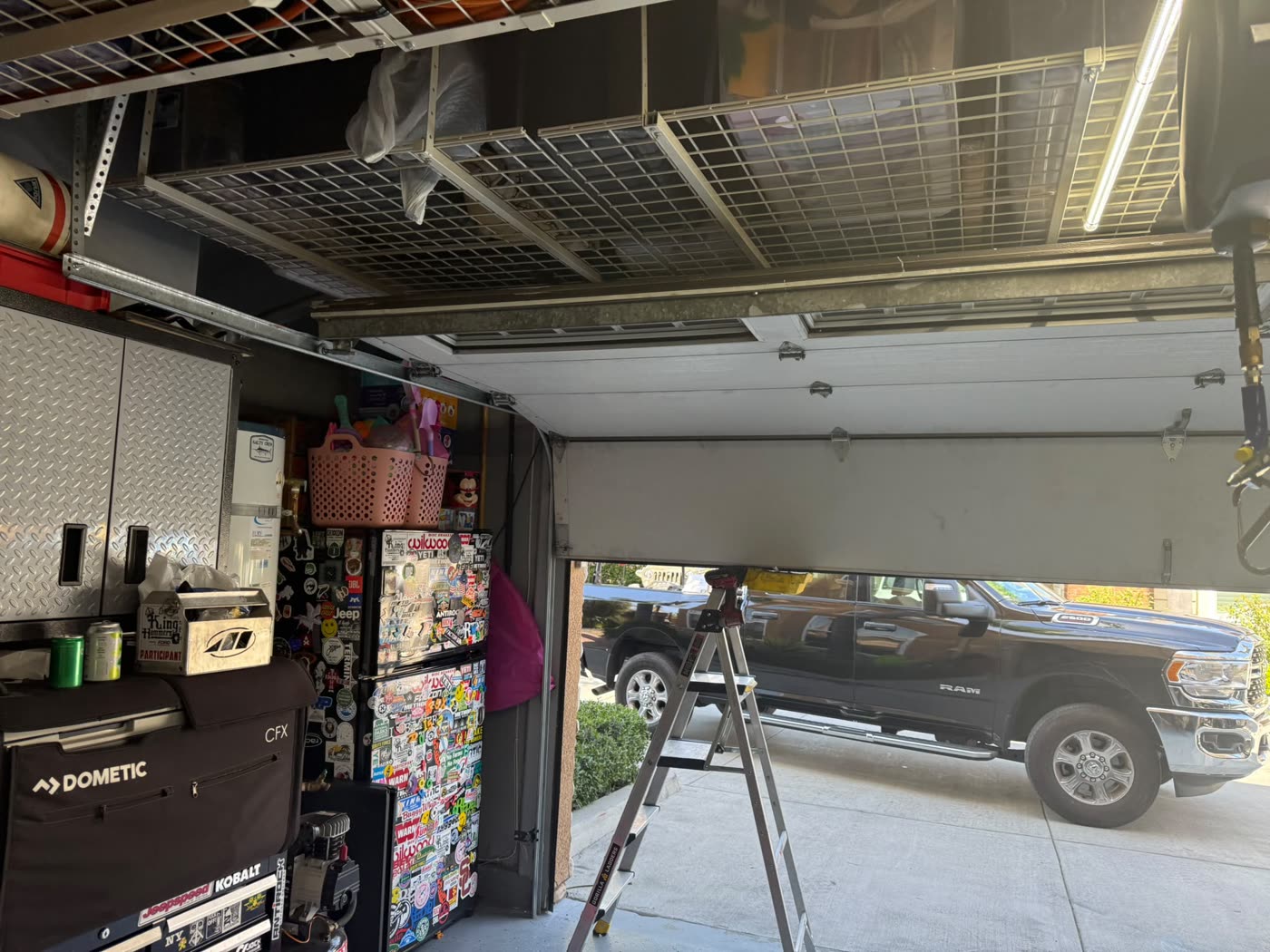 Garage door with bent bottom panel after being backed into, before repair