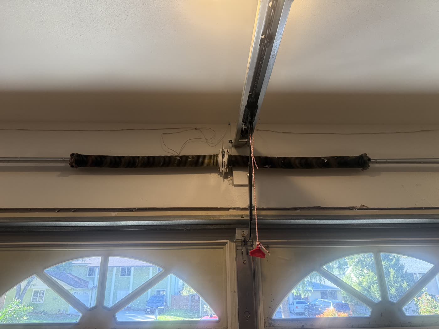Worn 15-year-old torsion springs above a garage door, flagged during an inspection before they could fail
